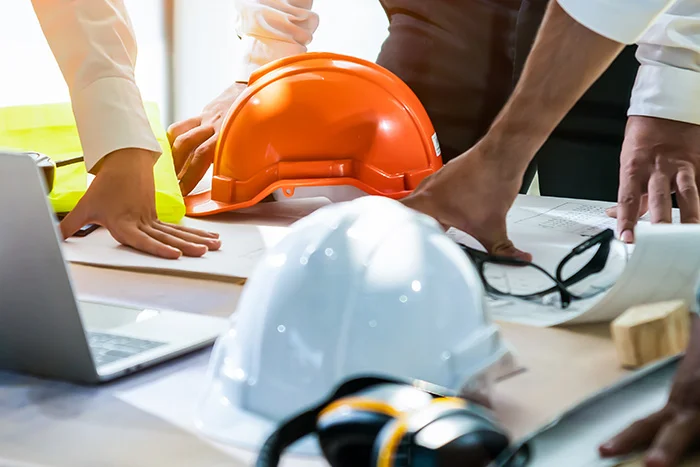 Visual representing an office with construction helmets